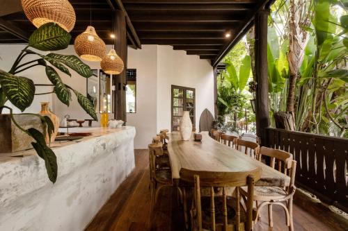 a dining room with a large wooden table and chairs at Huge 8 Bedrooms Pool Villa, Chiang Mai gem, Tanpuri Patan, perfect for Groups in Chiang Mai