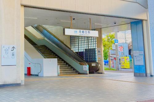 an escalator in a building with a staircase at 快客居と便利居 in Osaka