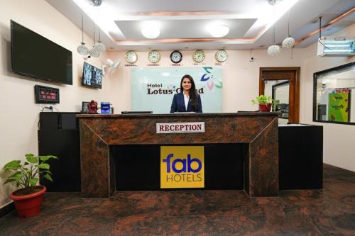 a woman standing at a podium in a room at Hotel L Grand - Nr Secunderabad Railway Station in Hyderabad