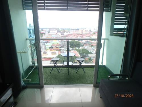 a room with a view of a balcony with a table at Nuha Studio Stay at D'perdana Apartment in Kota Bharu