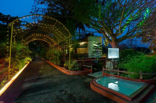a ride in a garden at night with a tree at The Whistling Pine Woods in Varagampadi