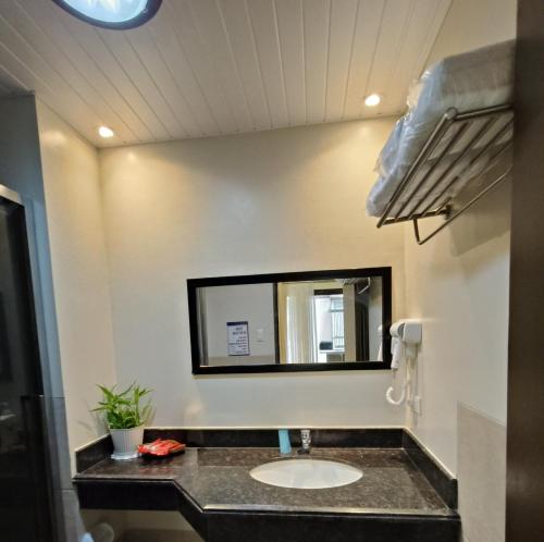 a bathroom with a sink and a mirror at 2-BR Condo near Major Tourist Spots in Baguio in Sampong