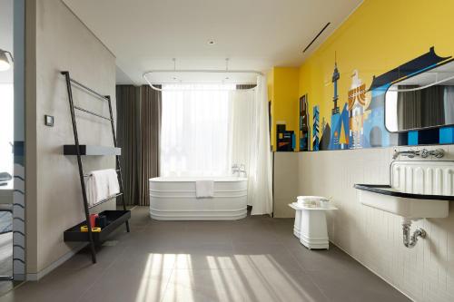 a bathroom with a white tub and a sink at L7 Myeongdong by LOTTE in Seoul