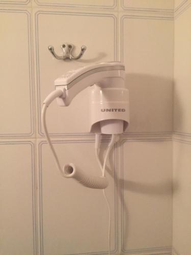 a hair dryer is attached to a wall at Fotini's Beach in Olympiaki Akti