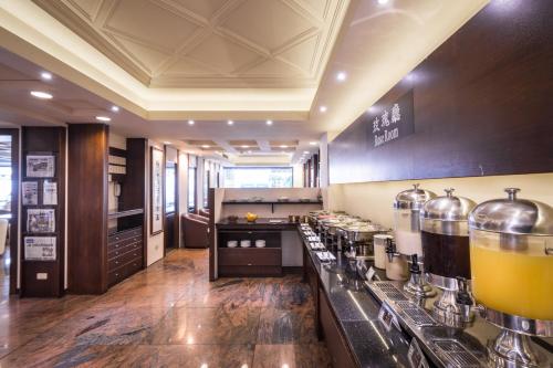 a large kitchen with a counter with many bottles of juice at The Enterpriser Hotel in Taichung