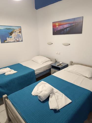 a bedroom with two beds and a tv on the wall at Fotini's Beach in Olympic Beach