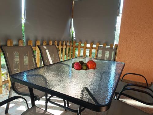 a table with two apples on top of it at Holiday Home Višnja with Pool in Benkovac