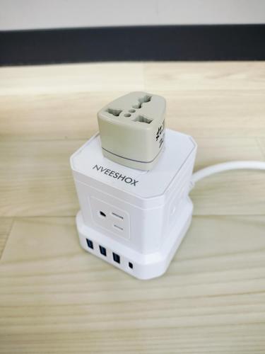 a white wii router sitting on top of a wooden floor at Family Home Osaka Awaji Guest House in Osaka