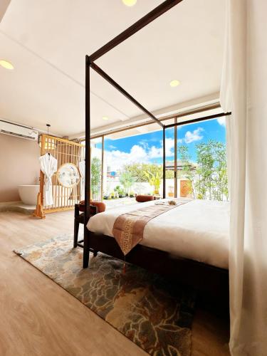 a bedroom with a large bed and a large window at Chinatown No9 Boutique Hotel in Bangkok