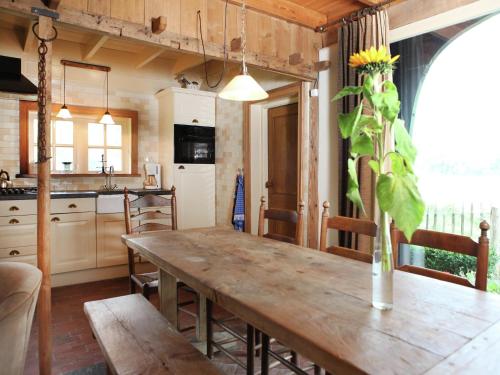 a kitchen with a wooden table with a vase on it at Cozy Apartment in Enschede near Forest in Enschede