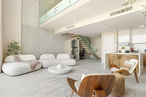 a living room with a couch and a table at Silkhaus Vacation Homes Sea View 1BR in Mamsha Al Saadiyat at Azure in Abu Dhabi