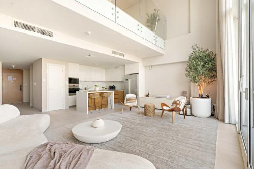 a living room with a couch and a table at Silkhaus Vacation Homes Sea View 1BR in Mamsha Al Saadiyat at Azure in Abu Dhabi