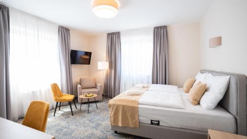 Postel nebo postele na pokoji v ubytování Kikelet Club Hotel