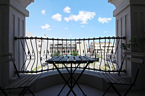 a balcony with a table and a view of a city at 22 B&B in Donggang
