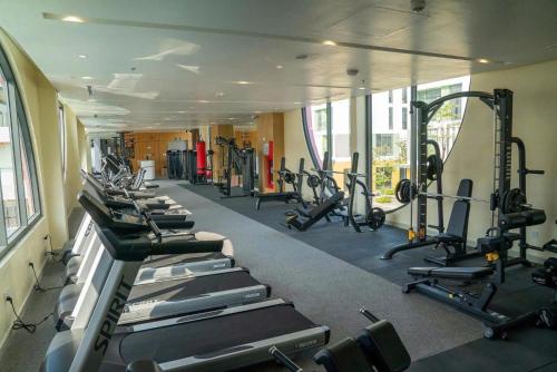 a gym with a row of treadmills and machines at The Kind Villas Phu Quoc in Phu Quoc
