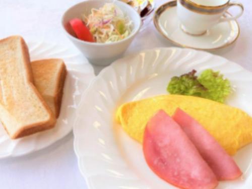 a white plate of food with bread and a sandwich and toast at Zuien Country Club Century Fuji Course in Manzawa