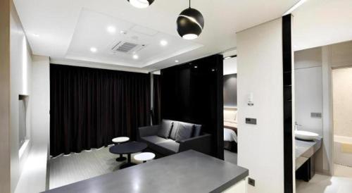 a living room with a couch and a chair in a room at Kintex by K-tree in Isan