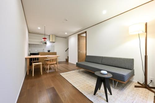 a living room with a couch and a table at casana KYOTO in Kyoto