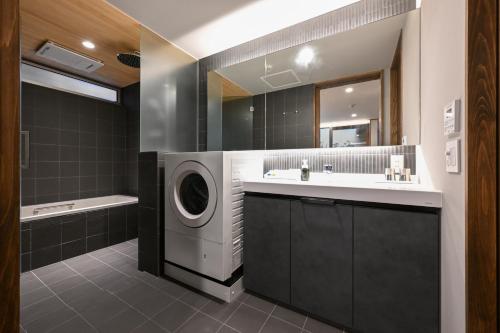 a bathroom with a washing machine and a sink at casana KYOTO in Kyoto