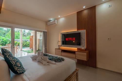 Ένα ή περισσότερα κρεβάτια σε δωμάτιο στο Inda Villa Ubud by Bali Cabin