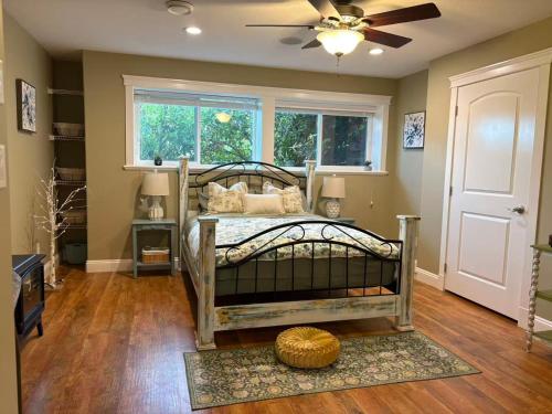 une chambre avec un lit avec un ventilateur et une fenêtre dans l'établissement A perfect getaway by the sea in North Nanaimo, à Nanaimo