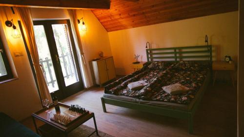 a bedroom with a large bed and a table at Zöldre Néző Vendégház in Letkés
