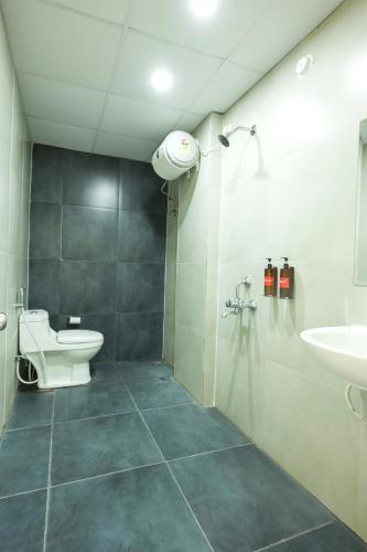 a bathroom with a toilet and a sink at Stae Hotel-Gachibowli in Hyderabad