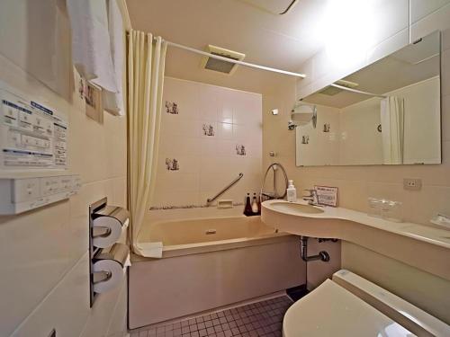 a bathroom with a sink and a shower and a toilet at Hotel Riverge Akebono in Omachi