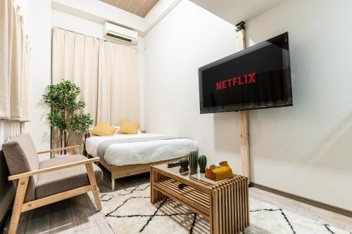 a living room with a television on a wall at リトリートコートキャナルシティ in Fukuoka