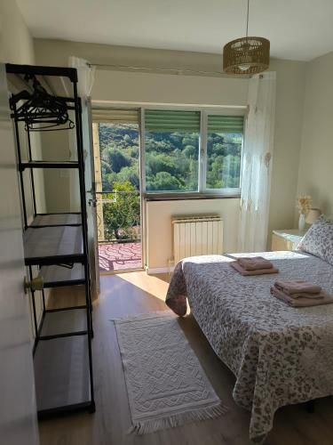 a bedroom with a bed with a ladder and a window at Casa las granxias in El Escobal