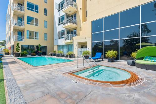 a pool in the courtyard of a building with a building at The Heart Of Hollywood Hills in Los Angeles