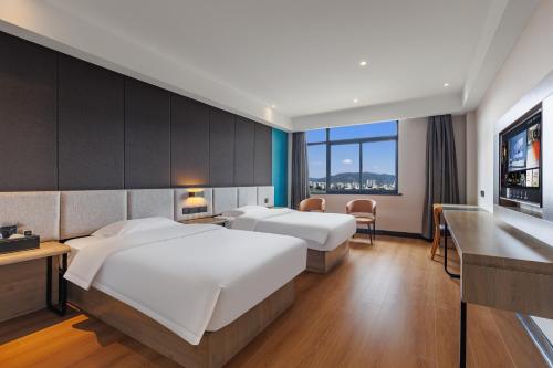 Postel nebo postele na pokoji v ubytování Manding Hotel