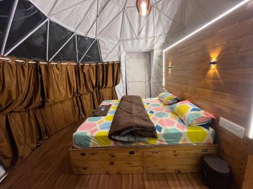 a bedroom with a bed in a tent at Kodai paradise in Dindigul