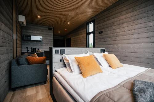a bedroom with a large bed and a chair at Lapland Winter Park Chalets in Rovaniemi