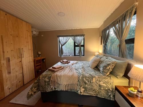a bedroom with a bed and a window at Erdvarkie at Kruger, Marloth Park in Marloth Park