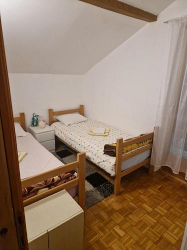 a small room with two beds in it at Vikend kuća Jović in Gornja Mahala