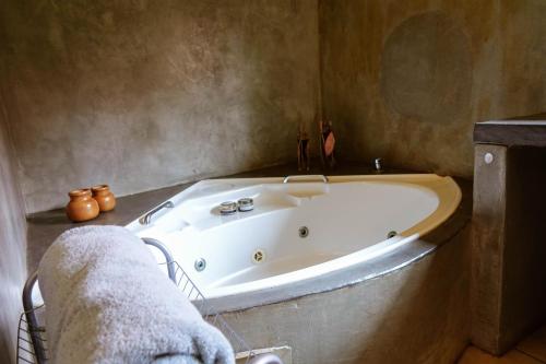 a bathroom with a bath tub in a room at Hluhluwe Homestead in Hluhluwe