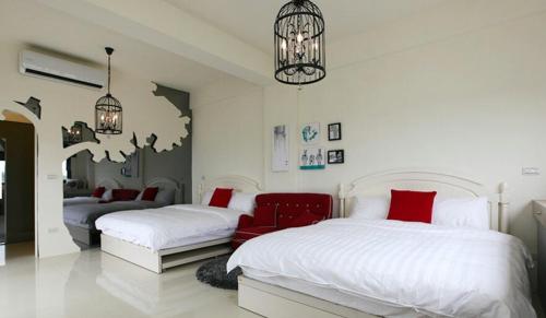 a bedroom with two beds and a chandelier at Hi Zebra Travel B&B in Dongshan