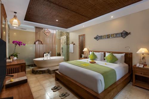 a bedroom with a bed and a bath tub and a bed and a bathroom at The Alena Resort a Pramana Experience in Ubud