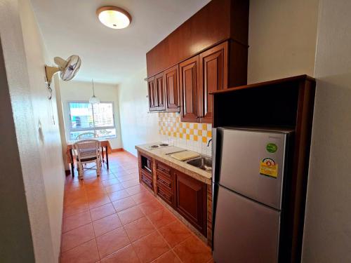 a kitchen with a refrigerator and a table in it at The Album Loft in Patong Beach