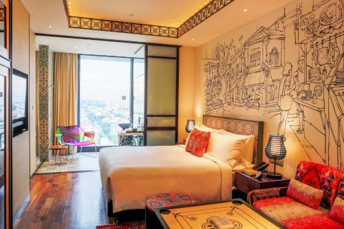 a hotel room with a bed and a drawing on the wall at Hotel Indigo Singapore Katong by IHG in Singapore