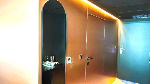 a bathroom with a shower with a large wooden door at Czarna Góra- Biała Perła z mini aneksem - 403 in Sienna