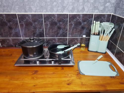 a kitchen counter with a stove with a pot on it at 2 Bed, King XL Bed, Dining&Office Space in Heathfield