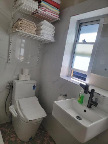 a bathroom with a toilet and a sink and a window at Close to the famous Bondi Beach in Australia in Sydney