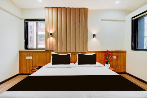 a bedroom with a large bed in a room at Super Townhouse Viman Nagar Business Stay Formerly Silver Crest in Pune