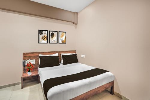 ein Schlafzimmer mit einem großen Bett in einem Zimmer in der Unterkunft Super Collection O Palampur Surat Formerly Hotel Royal Paradise in Bhatha