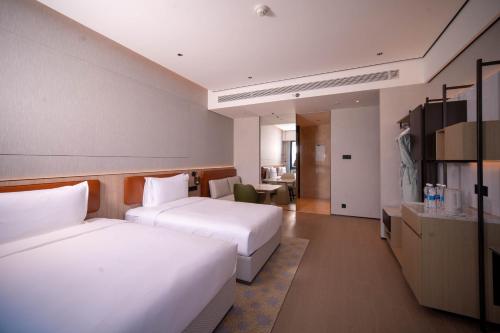 a hotel room with two beds and a kitchen at Holiday Inn Beijing Daxing Centre by IHG in Beijing