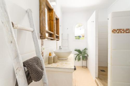 a bathroom with a white sink in a room at Villa Escaletas in Cala Santanyi