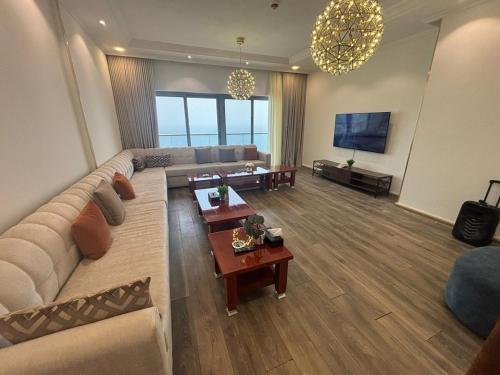 a living room with a couch and a tv at Elegant apartment overlooking the sea in Jeddah