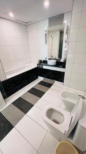 a bathroom with a toilet and a sink at Elegant apartment overlooking the sea in Jeddah
